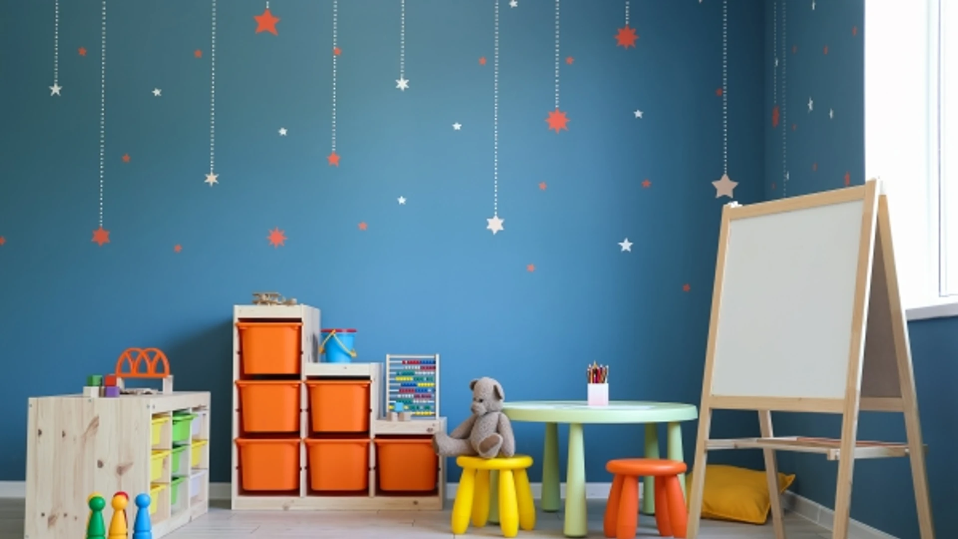Modern playroom with toys and white easel. Stars hanging from the ceiling.