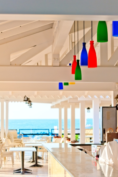 White Beachfront Restaurant with Multi-colored Hanging Lights  