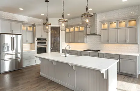 White cabinets in kitchen with island counter.
