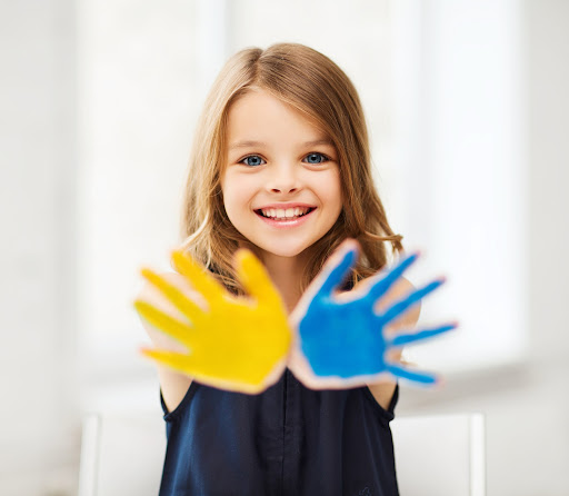 little girl with paint on her hands