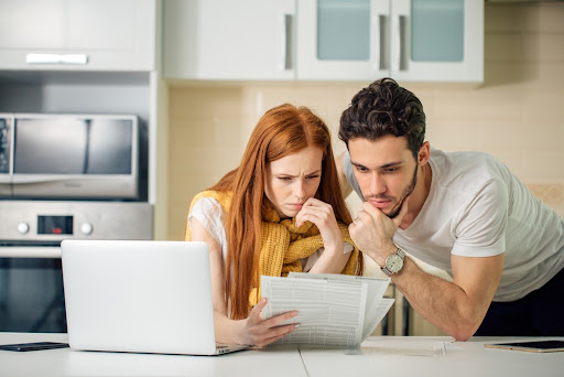 couple looking at papers in a kitchen