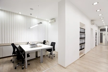 office space with white walls and a white desk