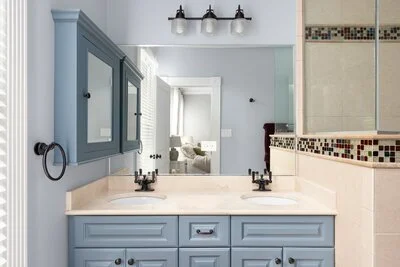 Master Bathroom with Off Gray Cabinets and Gray Walls.